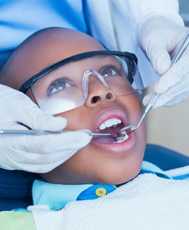 Boy getting a cleaning at the dentist