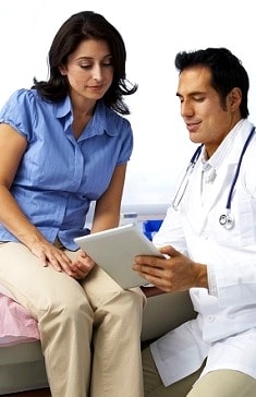 Male doctor going over report with female patient