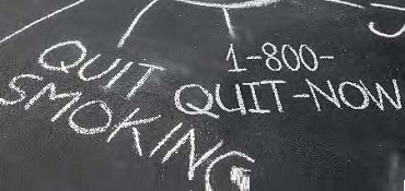 chalkboard with messages "quit smoking" and "1-800-quit-now"