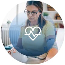woman checking blood pressure with hear rate icon
