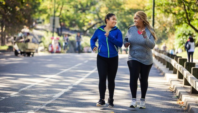 two women walking for exercise outside