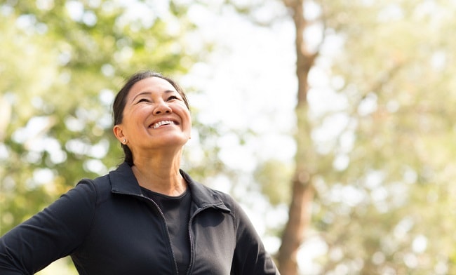 smiling woman outside for exercise