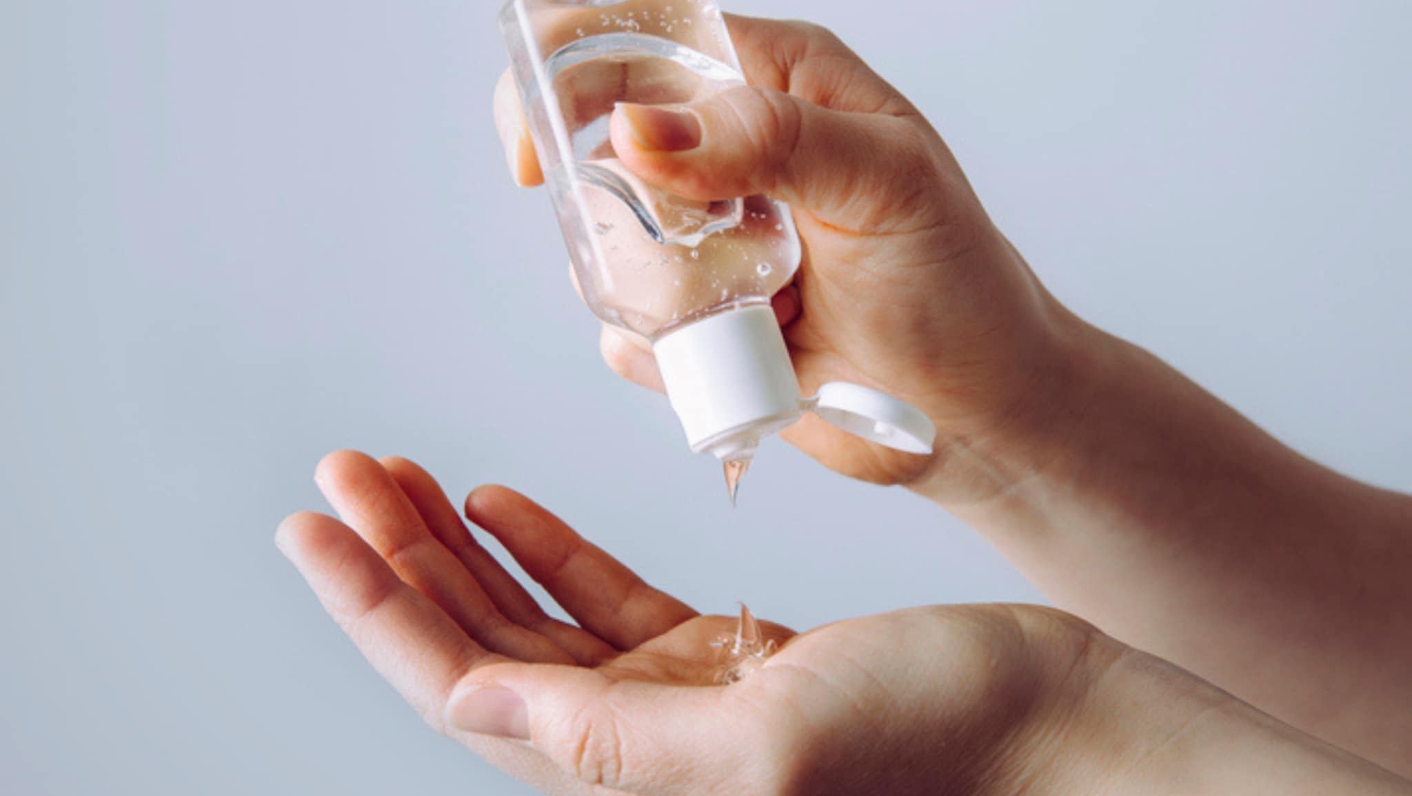 person using hand sanitizer