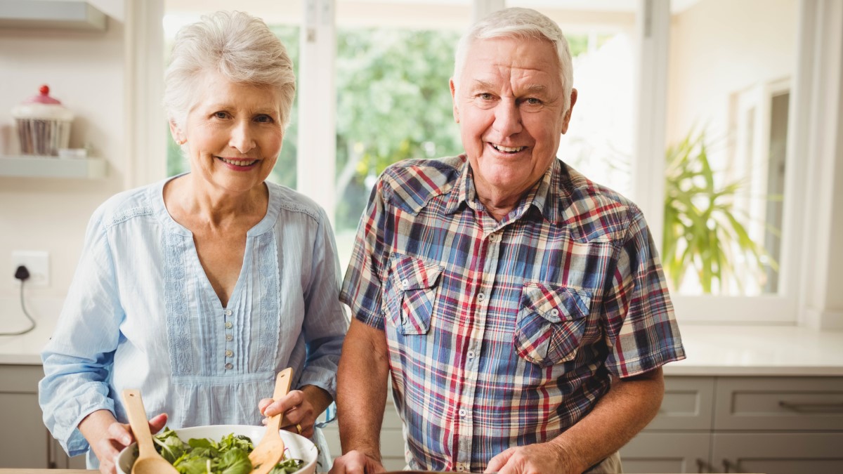 Photo of a man and a woman making a salad