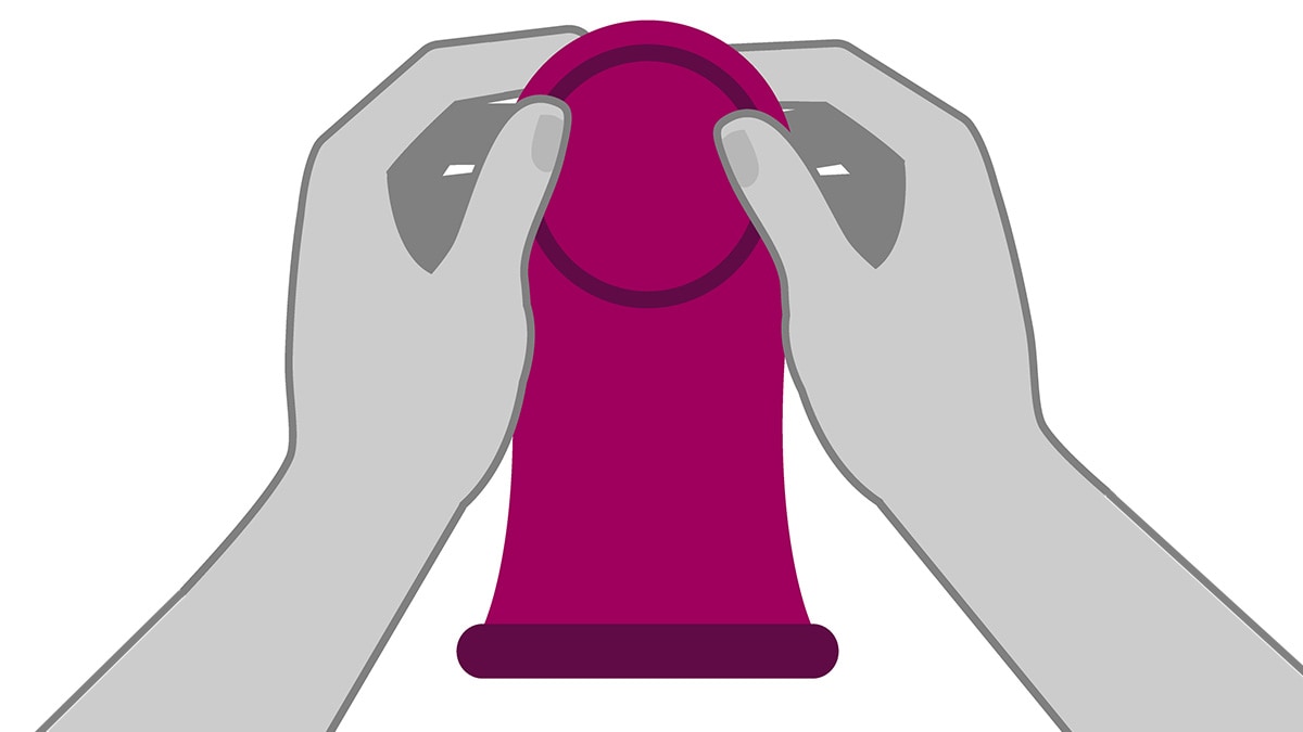 Hands holding a female (internal) condom.