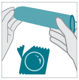 Hands holding condom and wrapper
