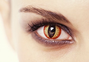 A woman wearing a decorative contact lens that resembles a cat's eye