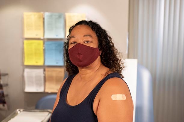 Vaccinated Hispanic woman with mask 