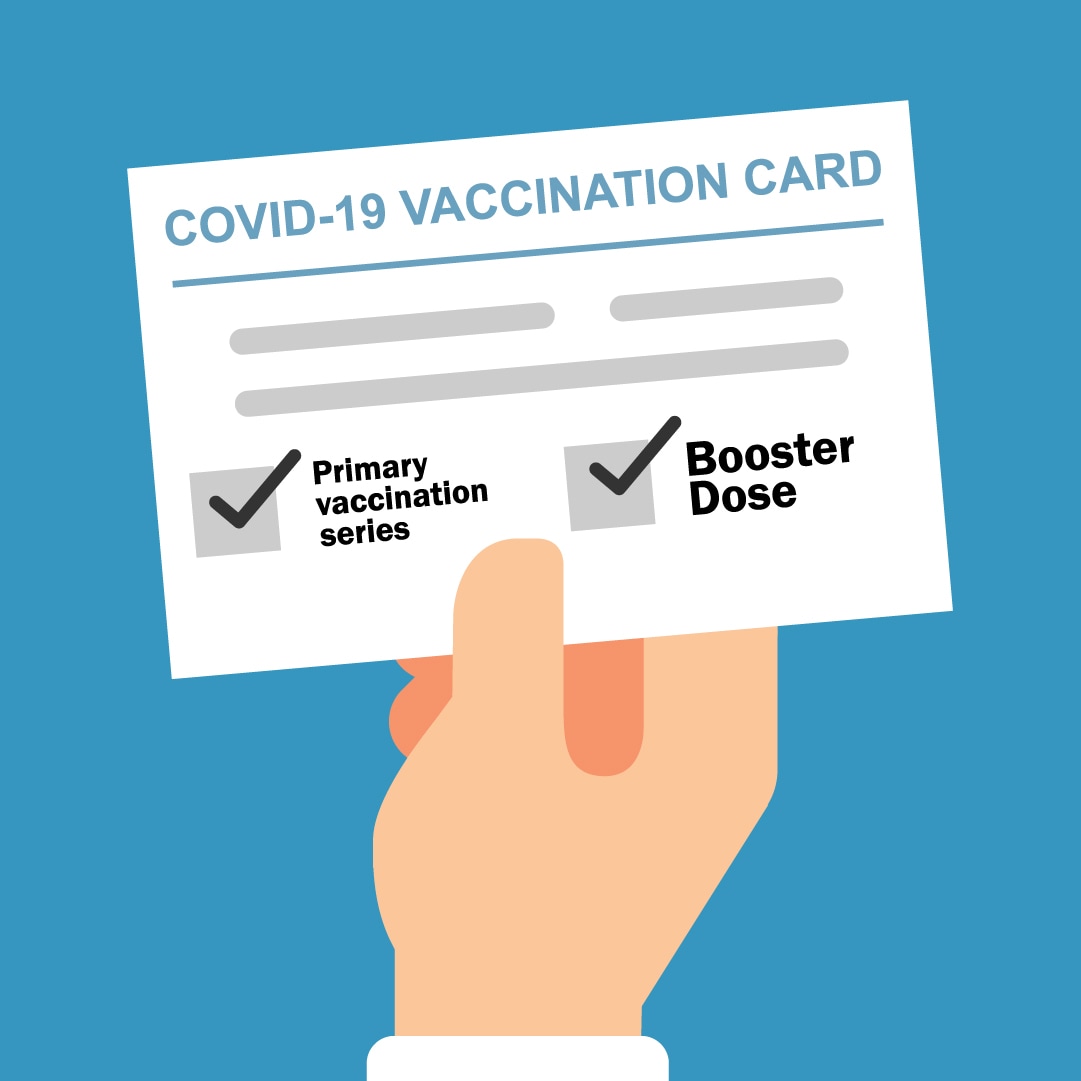 hand holding vaccination card with both boxes checked (primary vaccination series, and booster dose)