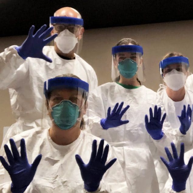 CDC deployers practice in personal protective equipment before going door-to-door to investigate a COVID-19 outbreak in Utah.