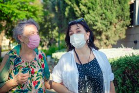 caregiver and client outdoors wearing masks