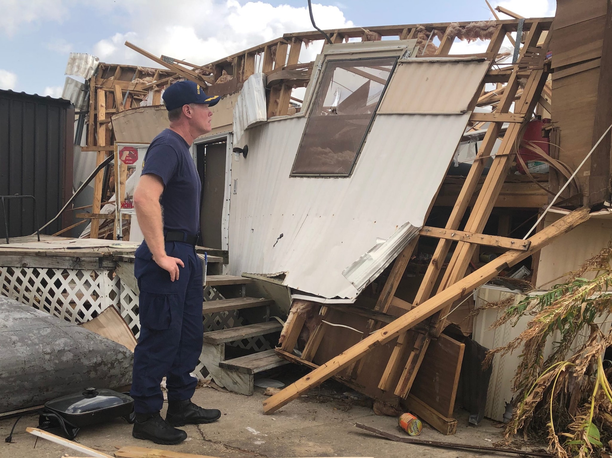 Troy Ritter inspecting a damaged mobile home 