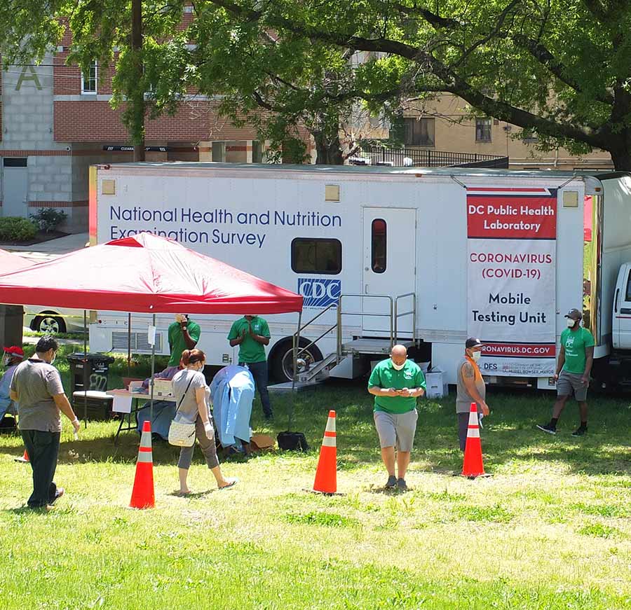 Photo of CDC mobile exam vehicle with people entering and leaving