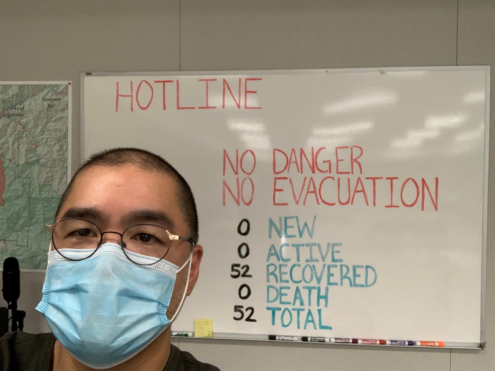 Scott Santibañez in front of marker board wearing mask