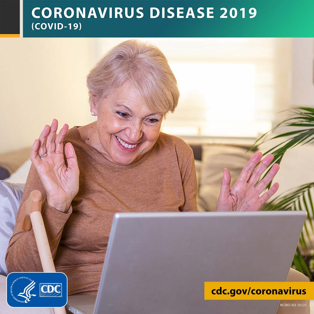 coronavirus disease 2019 covid-19 older adult at home smiling at computer with hands up cdc.gov/coronavirus