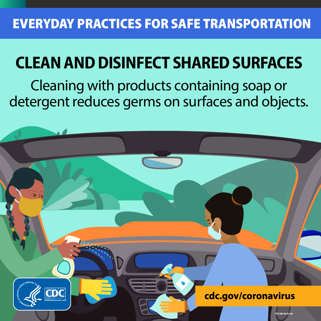 Image of two women cleaning surfaces in a vehicle