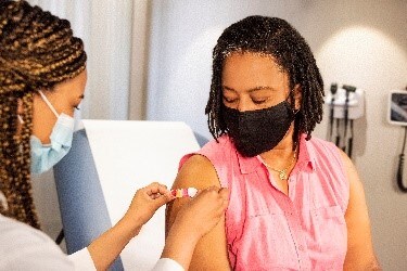 photo of woman receiving a vaccine