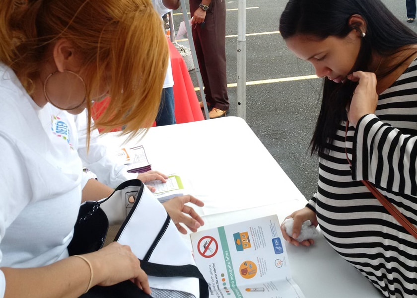 A pregnant women receives a Zika Prevention Kit and counseling at a Zika Action Day in Puerto Rico
