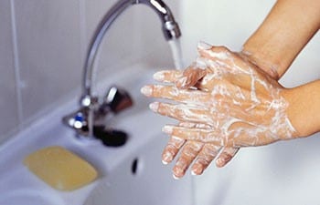 Closeup image of woman washing hands in sink