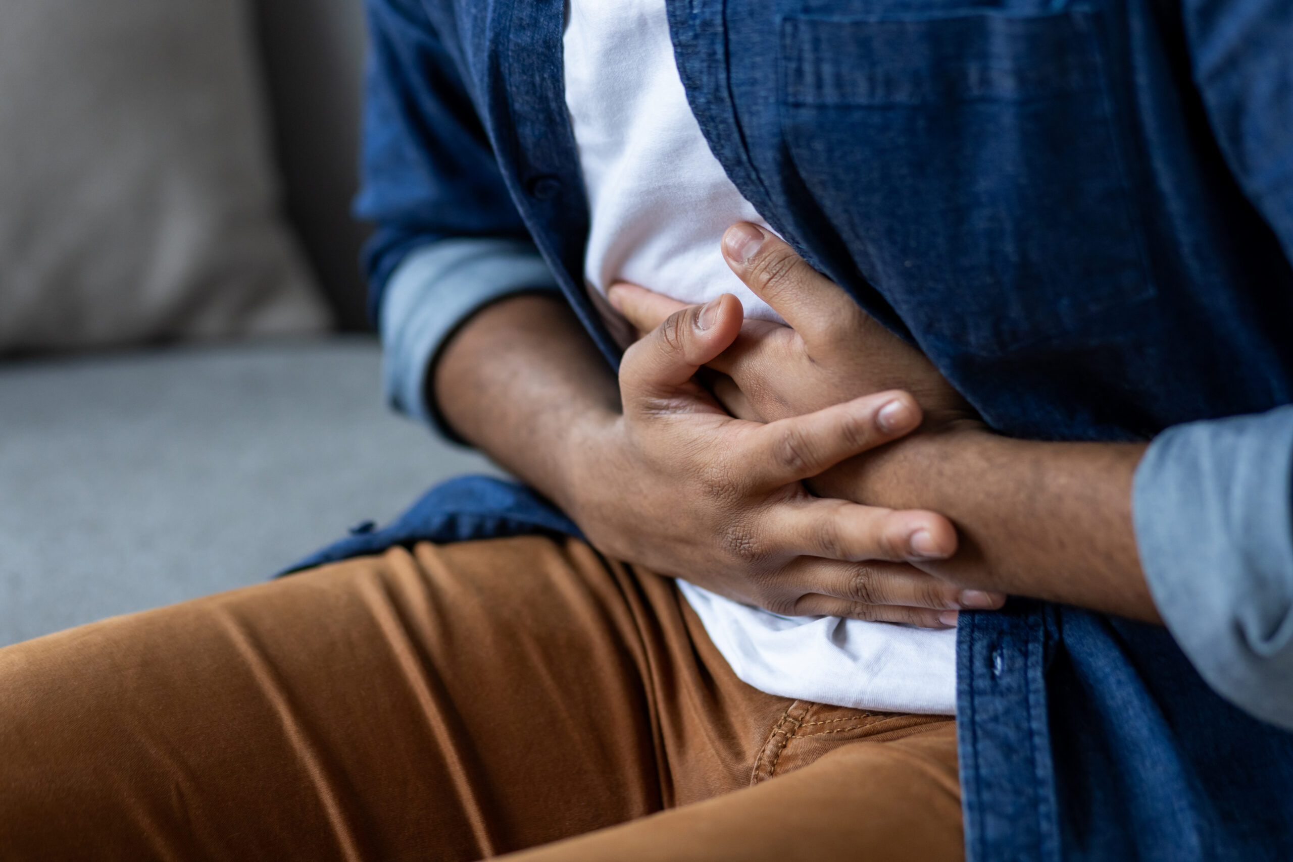 A man holds his stomach.