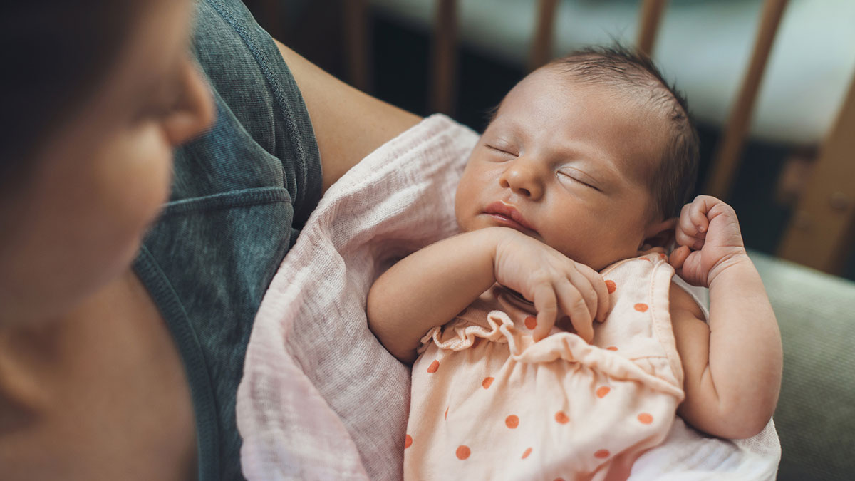 Mother cradling newborn.