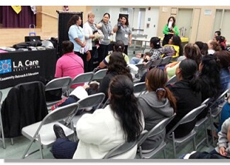 CHWs talking to an audience at an LA event.