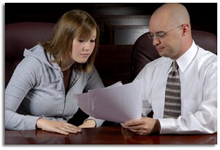 A man showing a woman some paperwork.