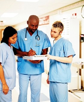 A group of physicians looking over a chart.