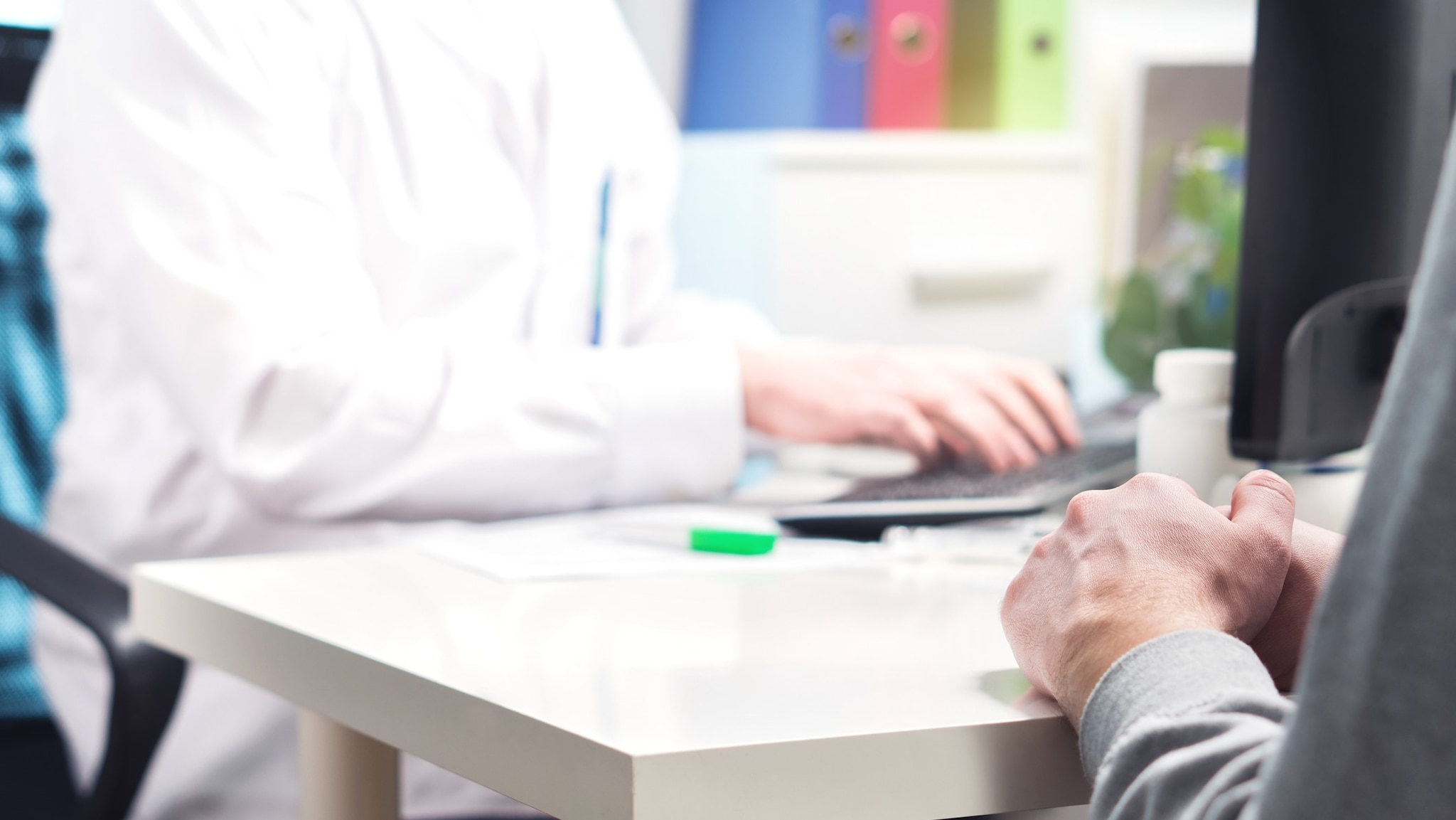 A health care professional updating an electronic health record for a patient