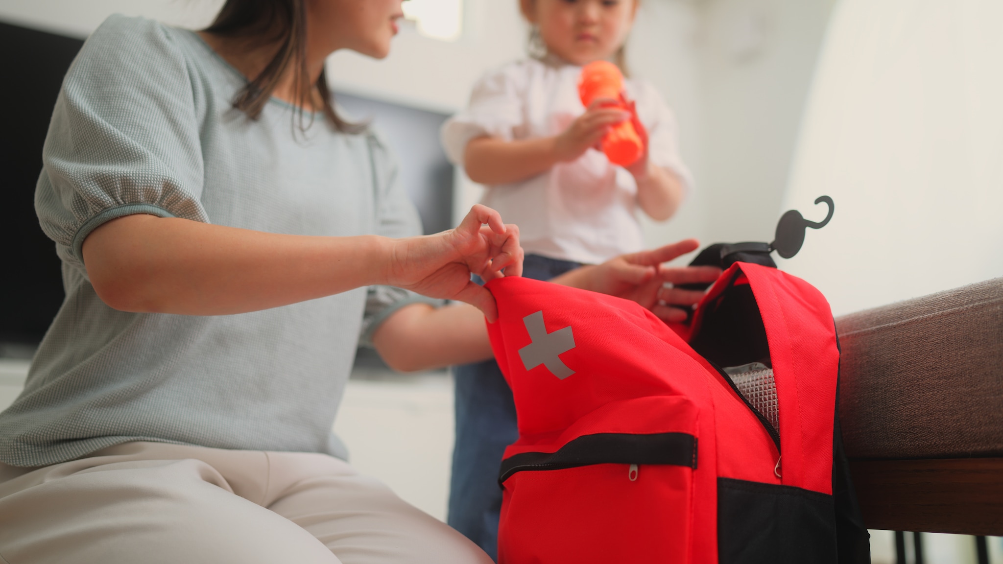 Woman packing child's bag for school