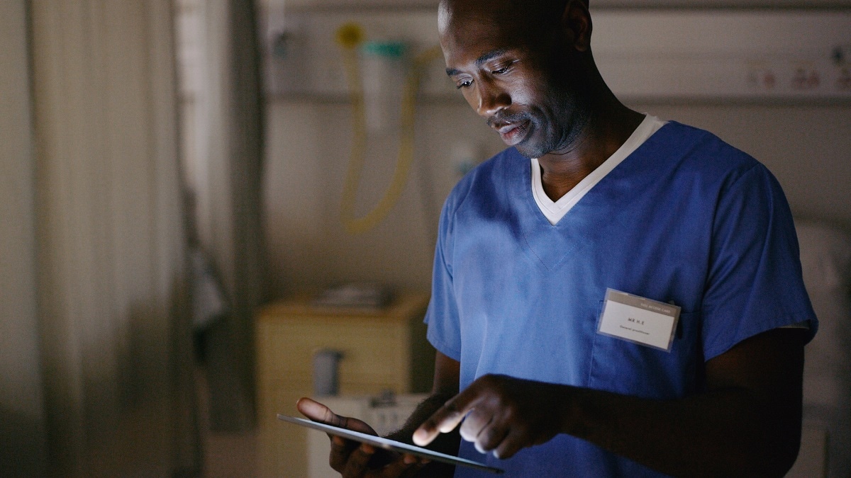 Black male health care worker at night in a hospital.