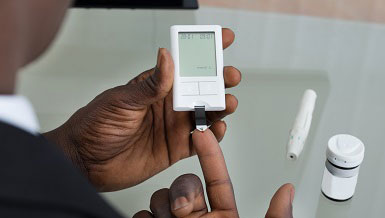 A patient using a Glucometer