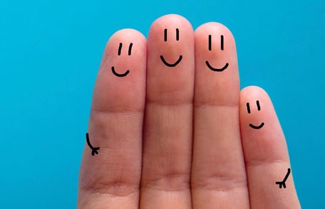 fingers with smiley faces drawn on them
