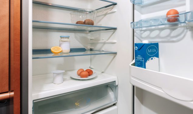 Open refrigerator with a limited food supply.