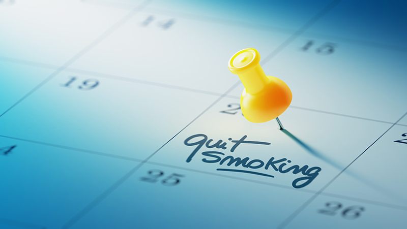 Quit Smoking Calendar Calendar with yellow pin and 'quit smoking' written as reminder.