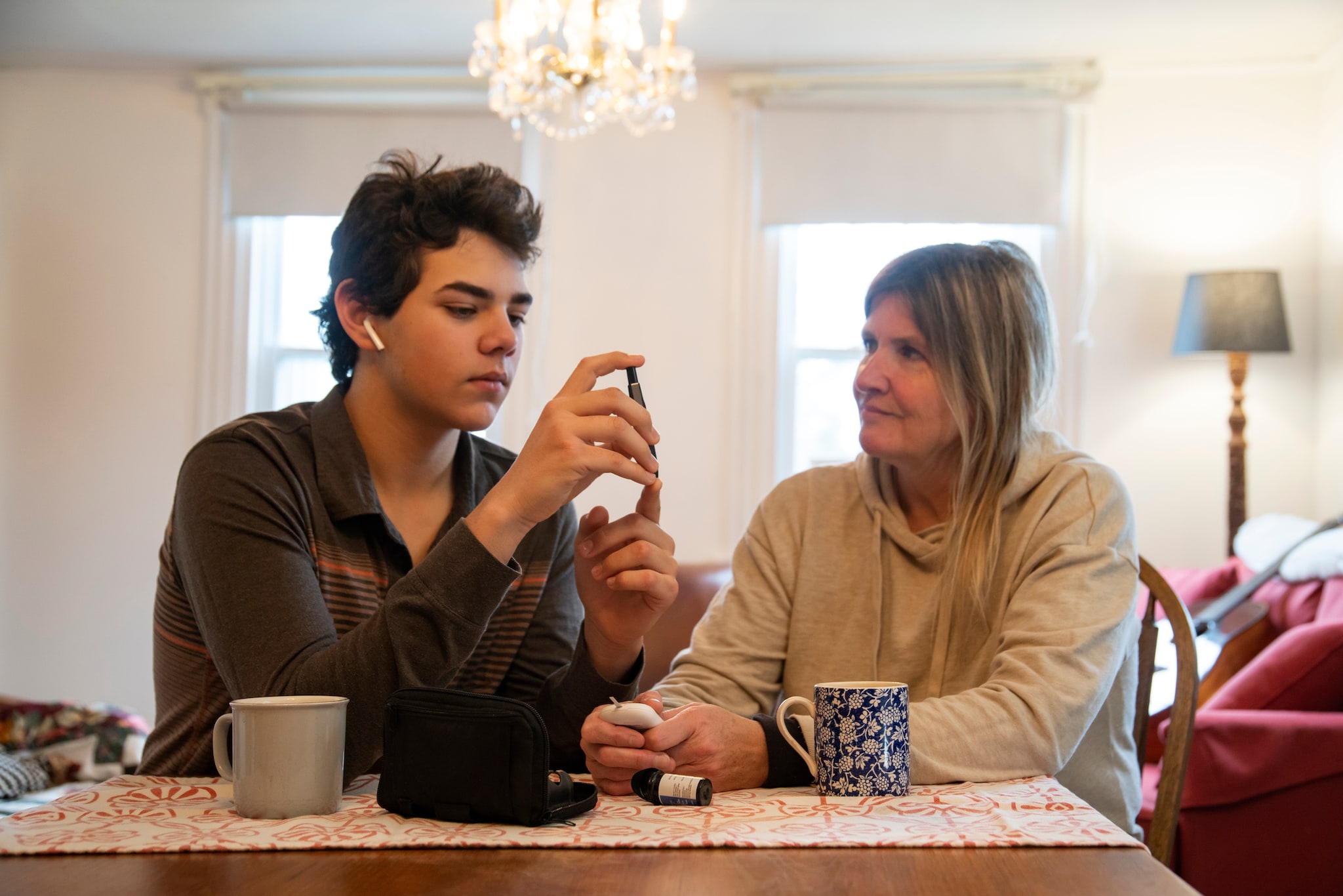 A diabetic teen patient at home with his mother.