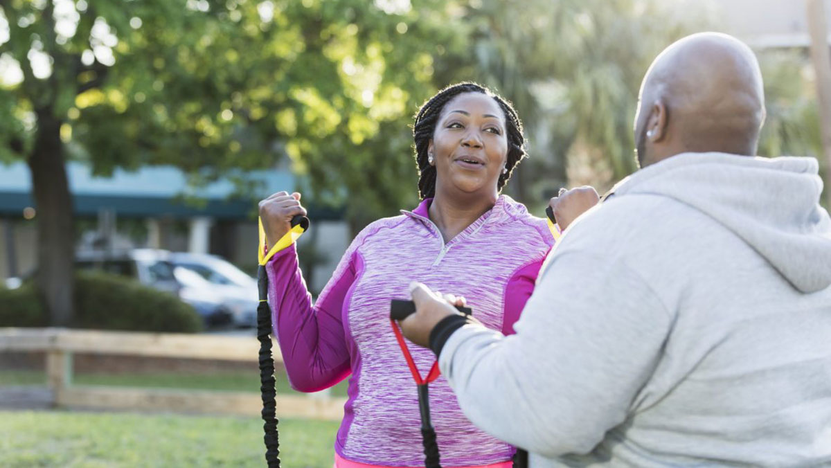 African American couple exercising in the part