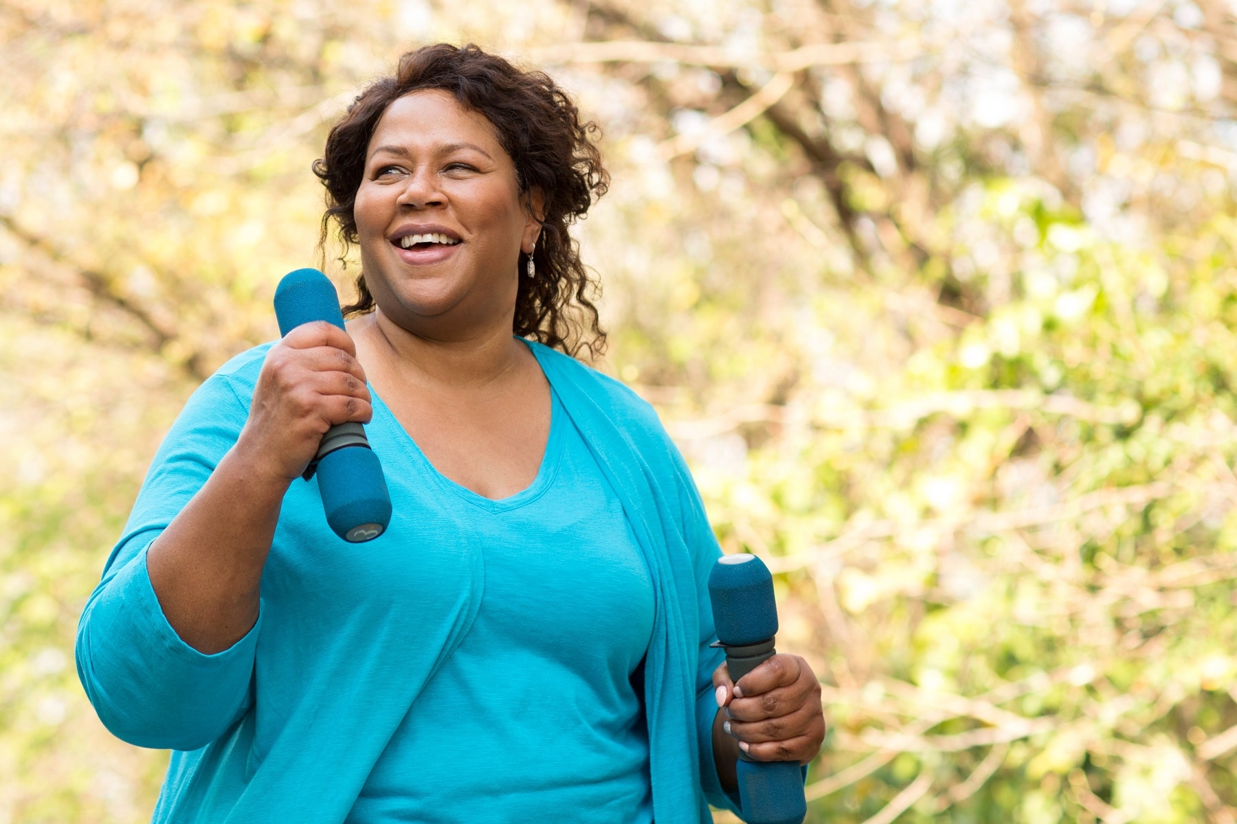 Mature African American woman smiling and exercising.