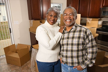 couple in a room surrounding by moving boxes
