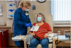 Healthcare worker with a patient at a dialysis facility