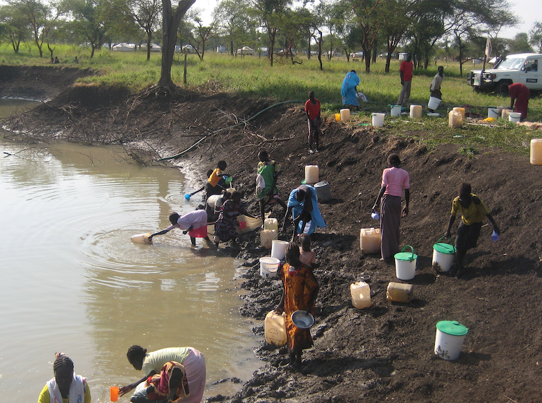 people collect water from muddy pond