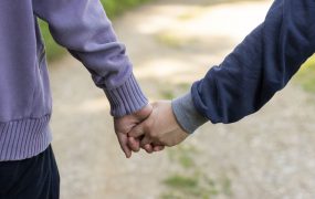 A picture of a couple walking and holding hands