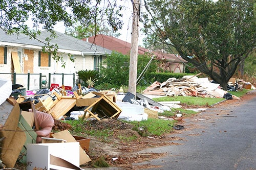 trash and debris outside houses after a flood