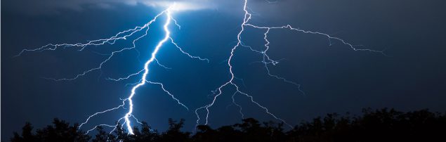A large lightning bold strikes the ground.