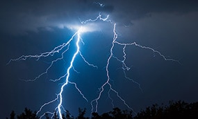 A large lightning bolt strikes the ground
