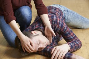 A man being placed in recovery position after accident