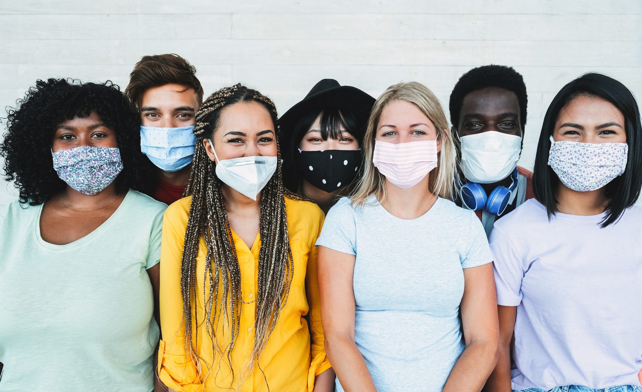 Young multiracial people wearing protective masks