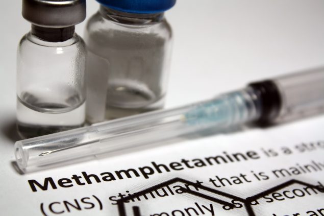 photo of liquid methamphetamine and a syringe
