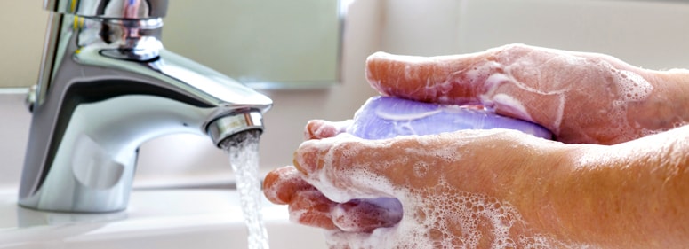 Man washing hand with a bar of soap