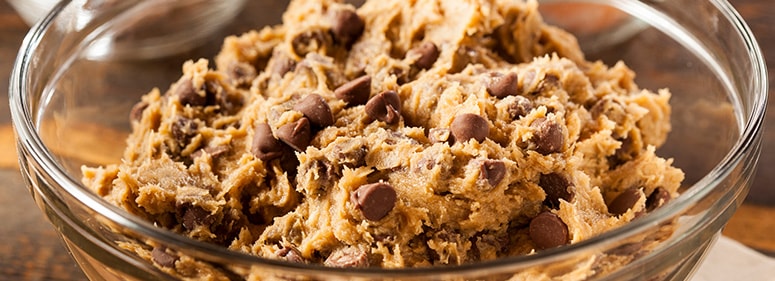 Photo of raw chocolate chip cookie dough in a bowl.